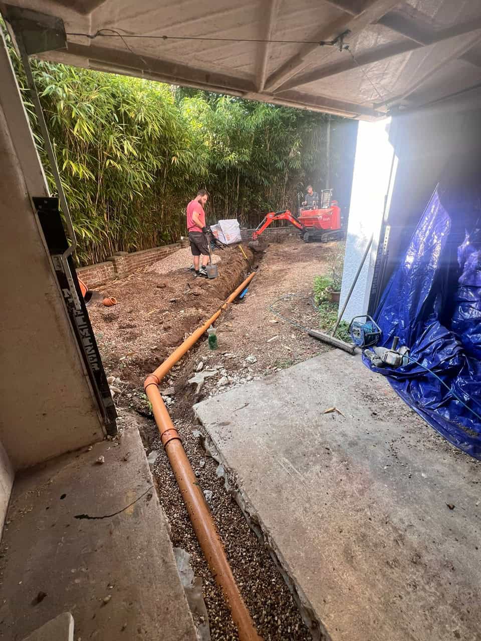 Drainage pipe being laid outdoors for effective water management.