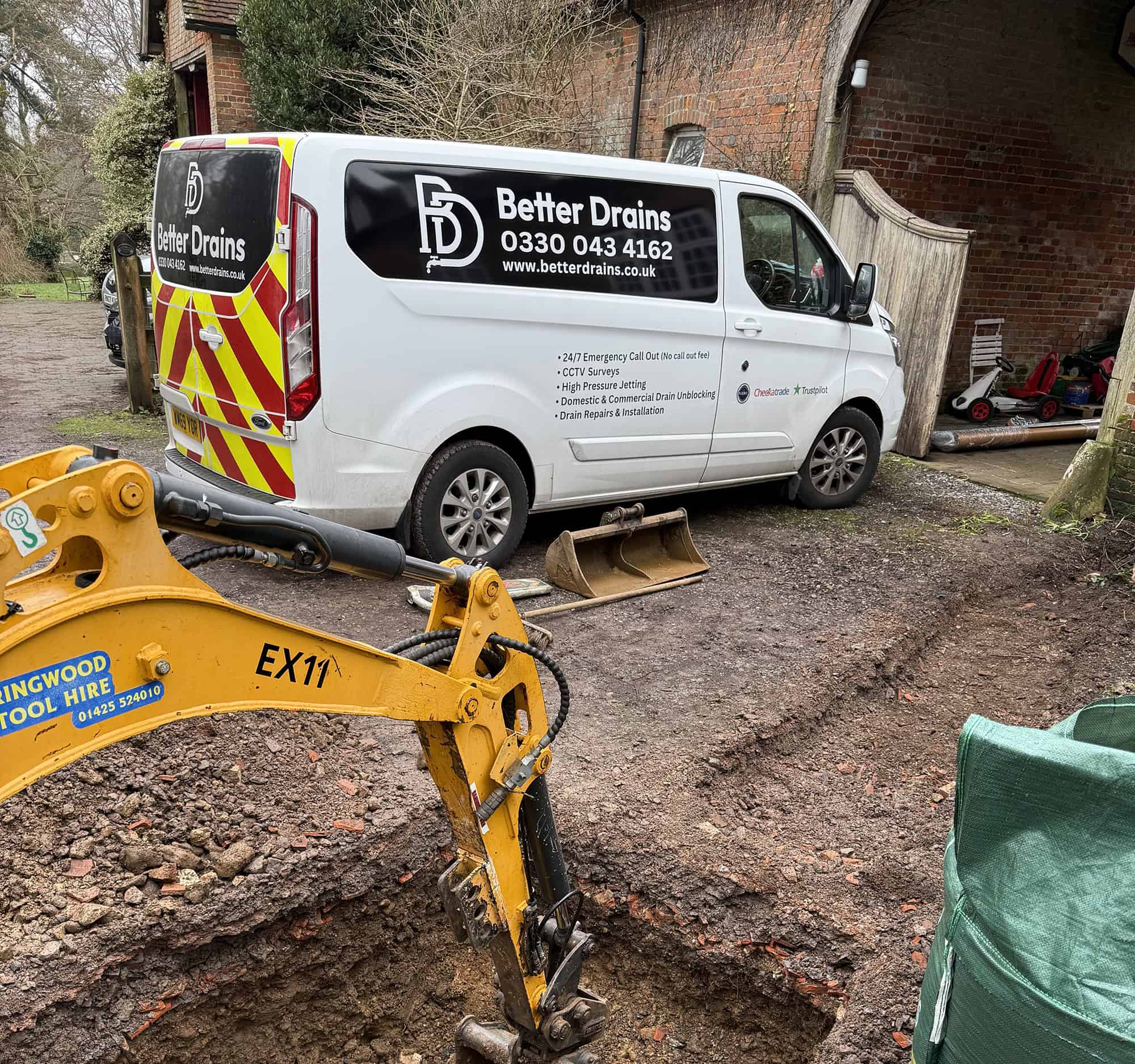 Better Drains van providing drainage services at a construction site.