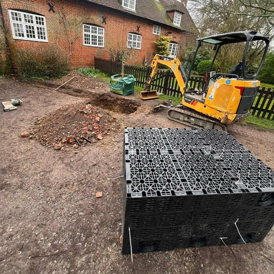 Construction site with drainage system and mini excavator.